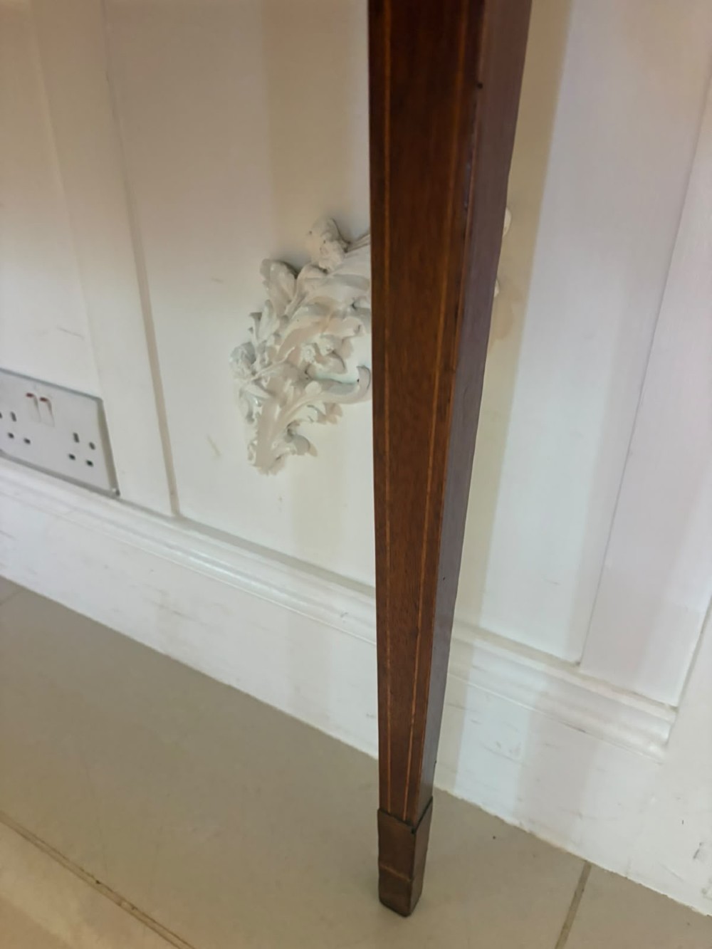 A pair of Georgian mahogany console tables featuring rounded corners, inlaid aprons, and slender tapered legs. View VI