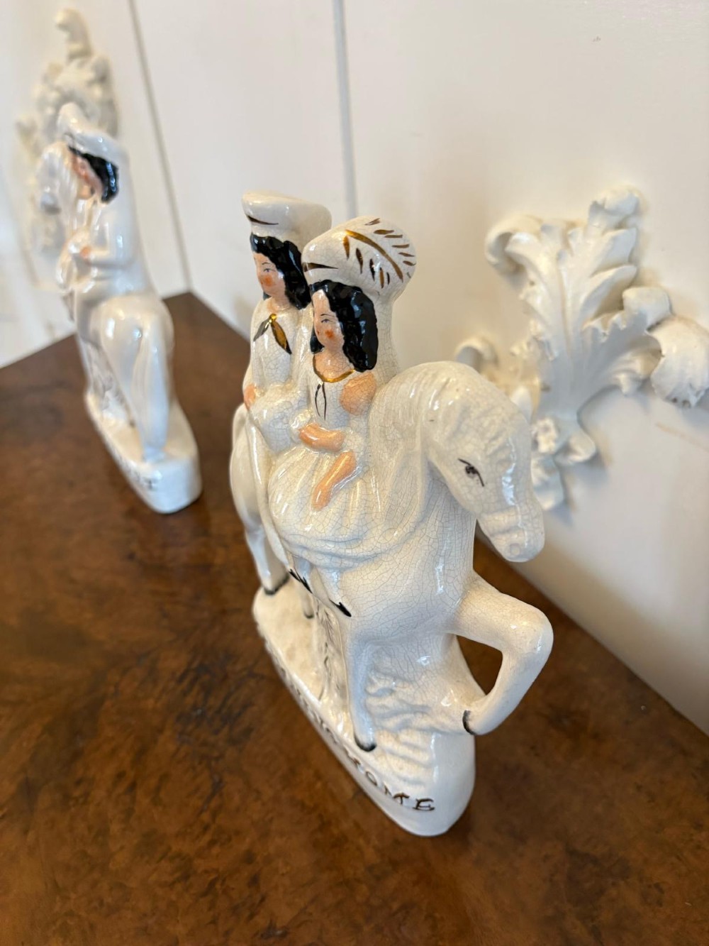 A pair of off-white antique Staffordshire flatback ceramic figures featuring riders on horseback titled Going to Market and Returning Home. View VI