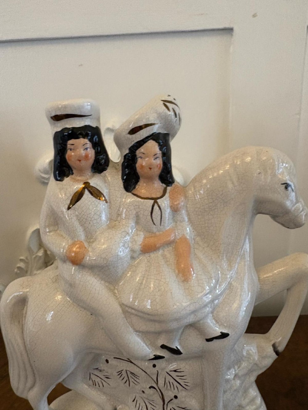 A pair of off-white antique Staffordshire flatback ceramic figures featuring riders on horseback titled Going to Market and Returning Home. View VII