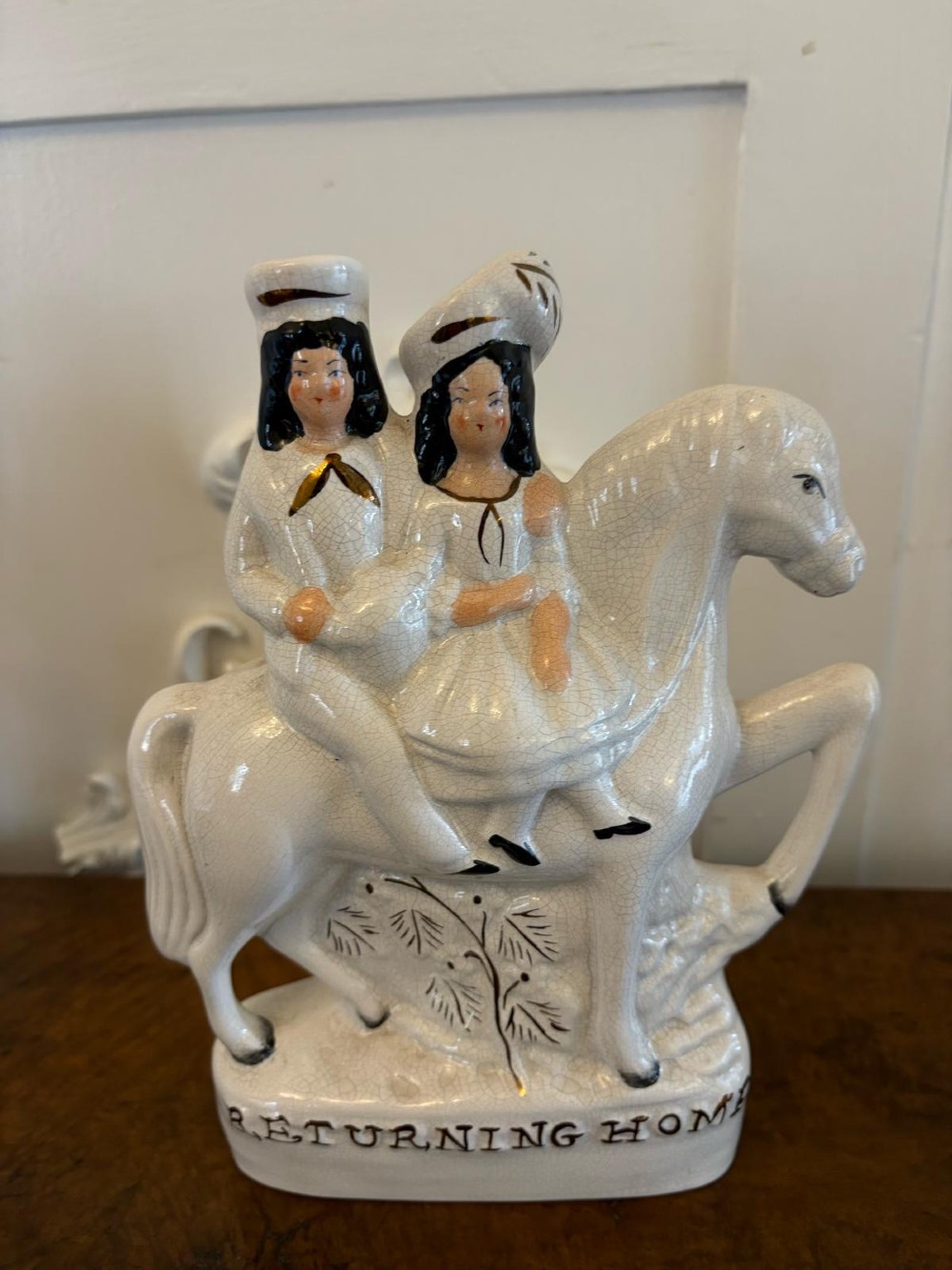 A pair of off-white antique Staffordshire flatback ceramic figures featuring riders on horseback titled Going to Market and Returning Home. View IX