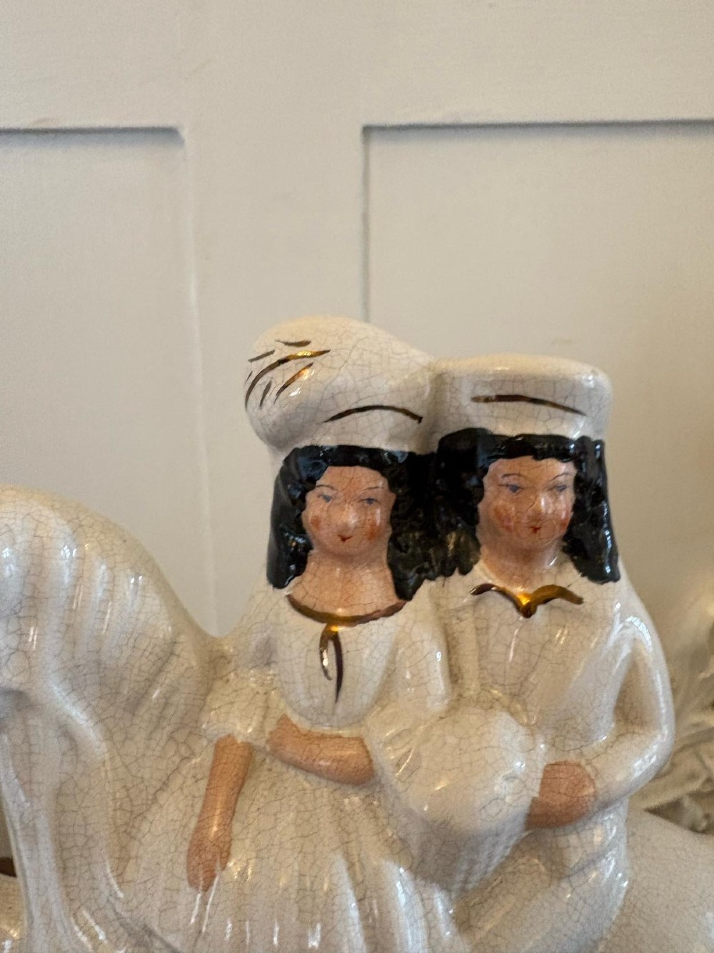 A pair of off-white antique Staffordshire flatback ceramic figures featuring riders on horseback titled Going to Market and Returning Home. View X