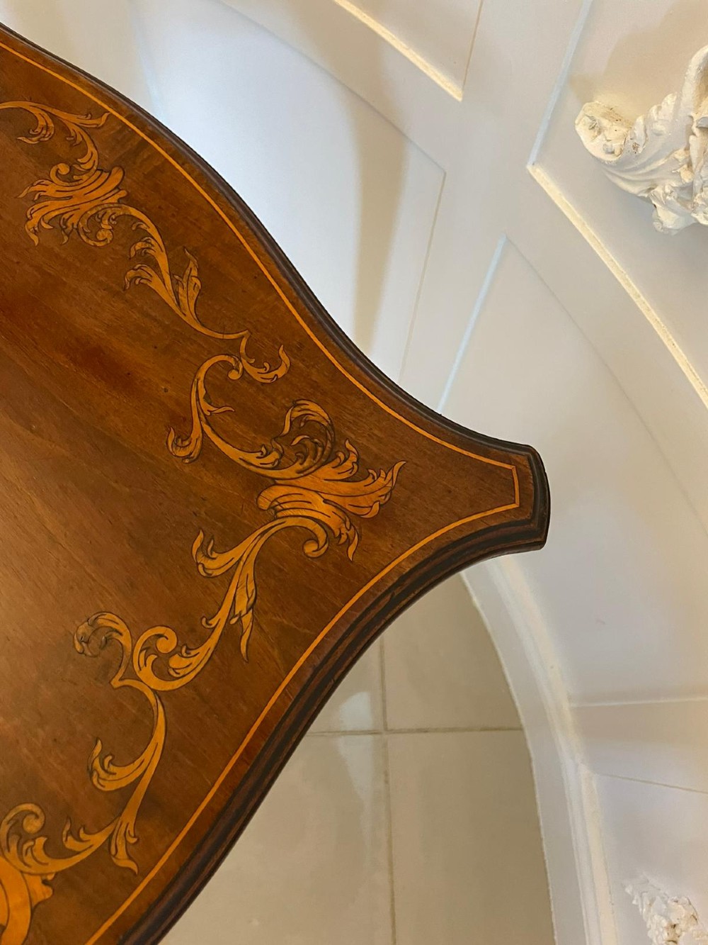 A Victorian mahogany side table featuring detailed marquetry inlay of musical instruments on a serpentine top supported by four cabriole legs. View III