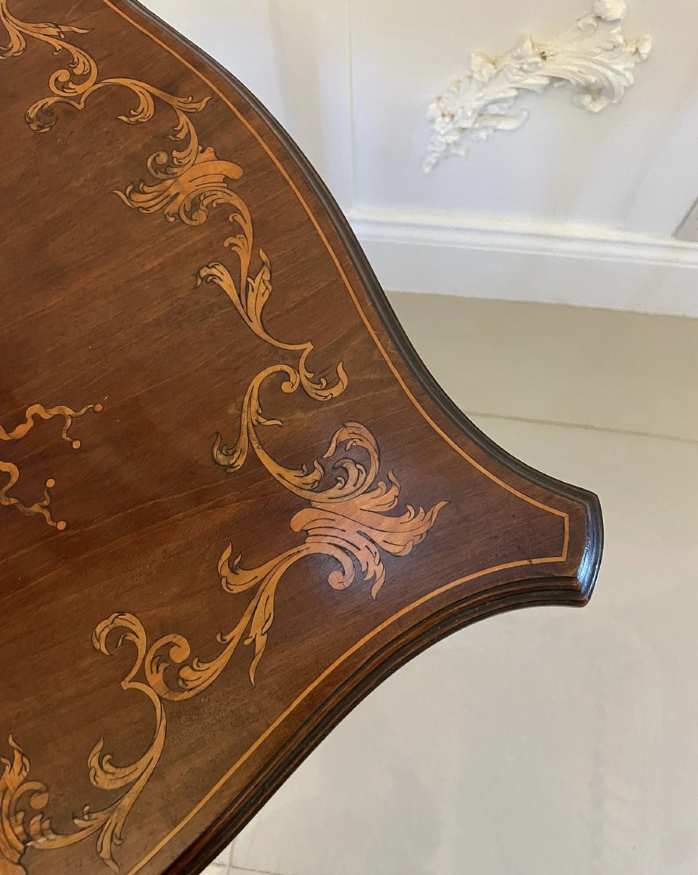 A Victorian mahogany side table featuring detailed marquetry inlay of musical instruments on a serpentine top supported by four cabriole legs. View IX