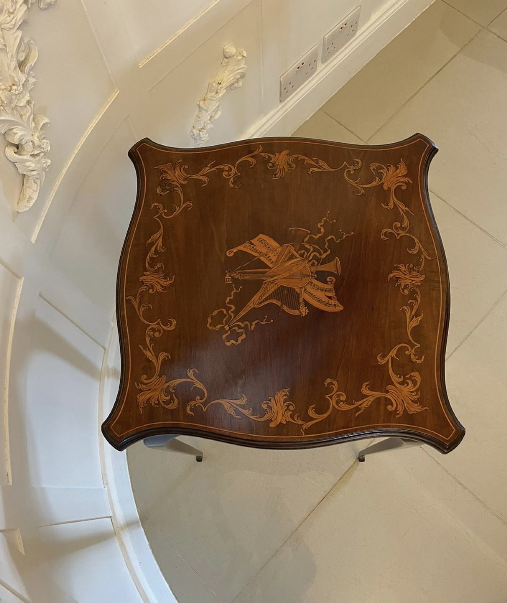 A Victorian mahogany side table featuring detailed marquetry inlay of musical instruments on a serpentine top supported by four cabriole legs. View XI