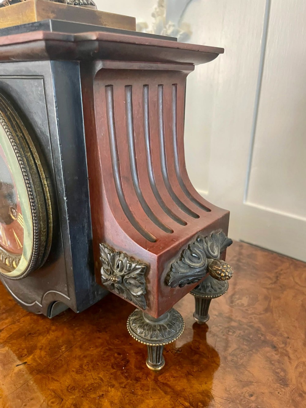 A Regency bronze and marble clock set featuring a central figure-topped mantel clock flanked by a pair of three-branch candelabra. View IX
