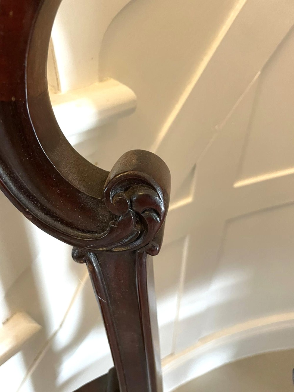 A Victorian carved mahogany settee featuring upholstered blue and white floral pattern seat and backrest, padded armrests, and carved cabriole legs. View IV