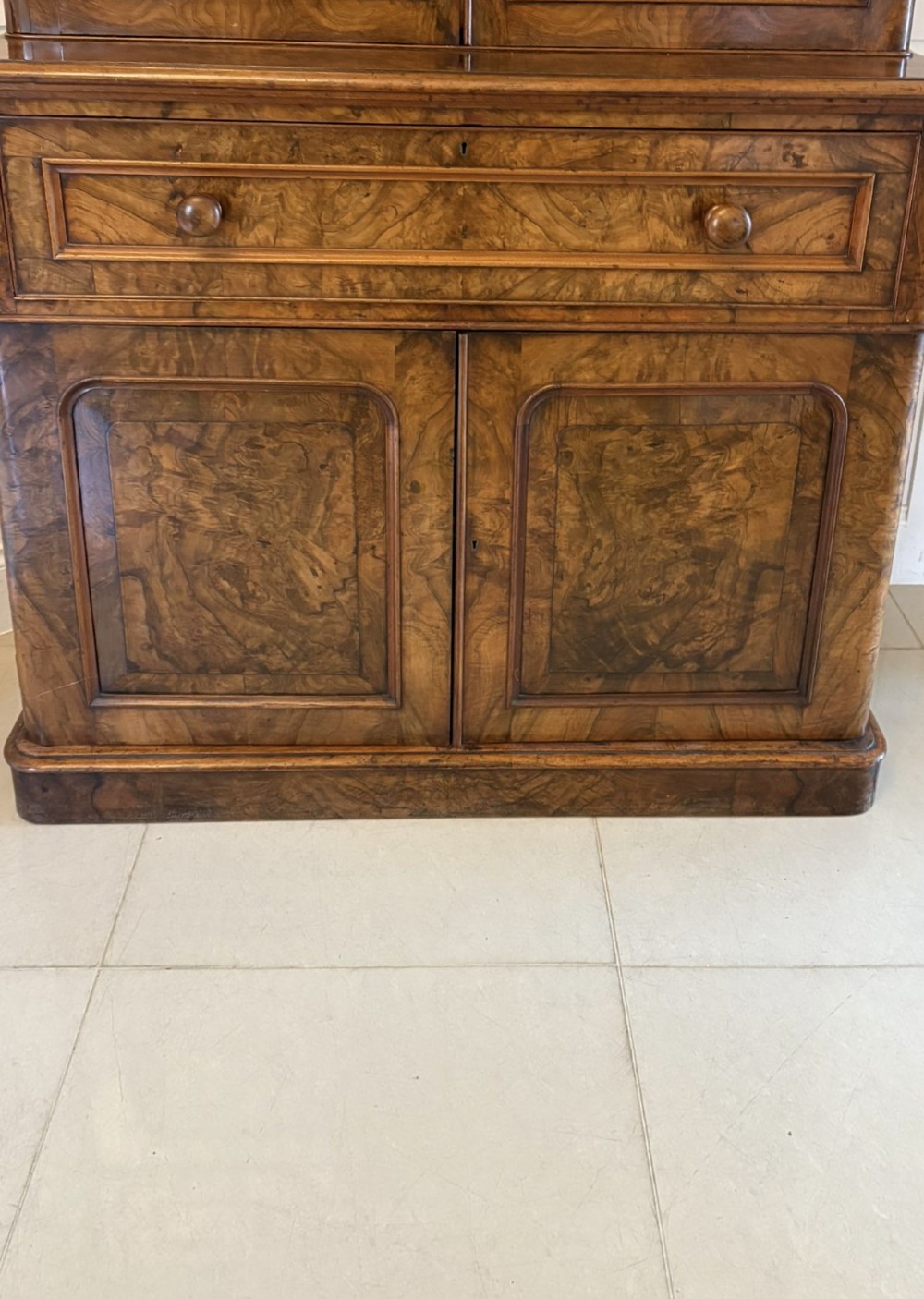 A Victorian burr walnut secretaire bookcase featuring a glazed upper cabinet with two doors, a deep secretaire drawer with turned wooden handles, and a two-door cupboard base. View VII