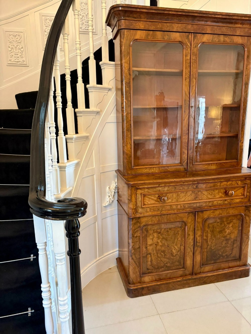 A Victorian burr walnut secretaire bookcase featuring a glazed upper cabinet with two doors, a deep secretaire drawer with turned wooden handles, and a two-door cupboard base. View VIII