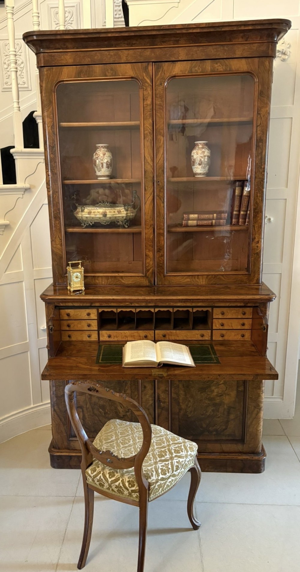 A Victorian burr walnut secretaire bookcase featuring a glazed upper cabinet with two doors, a deep secretaire drawer with turned wooden handles, and a two-door cupboard base. View XIII