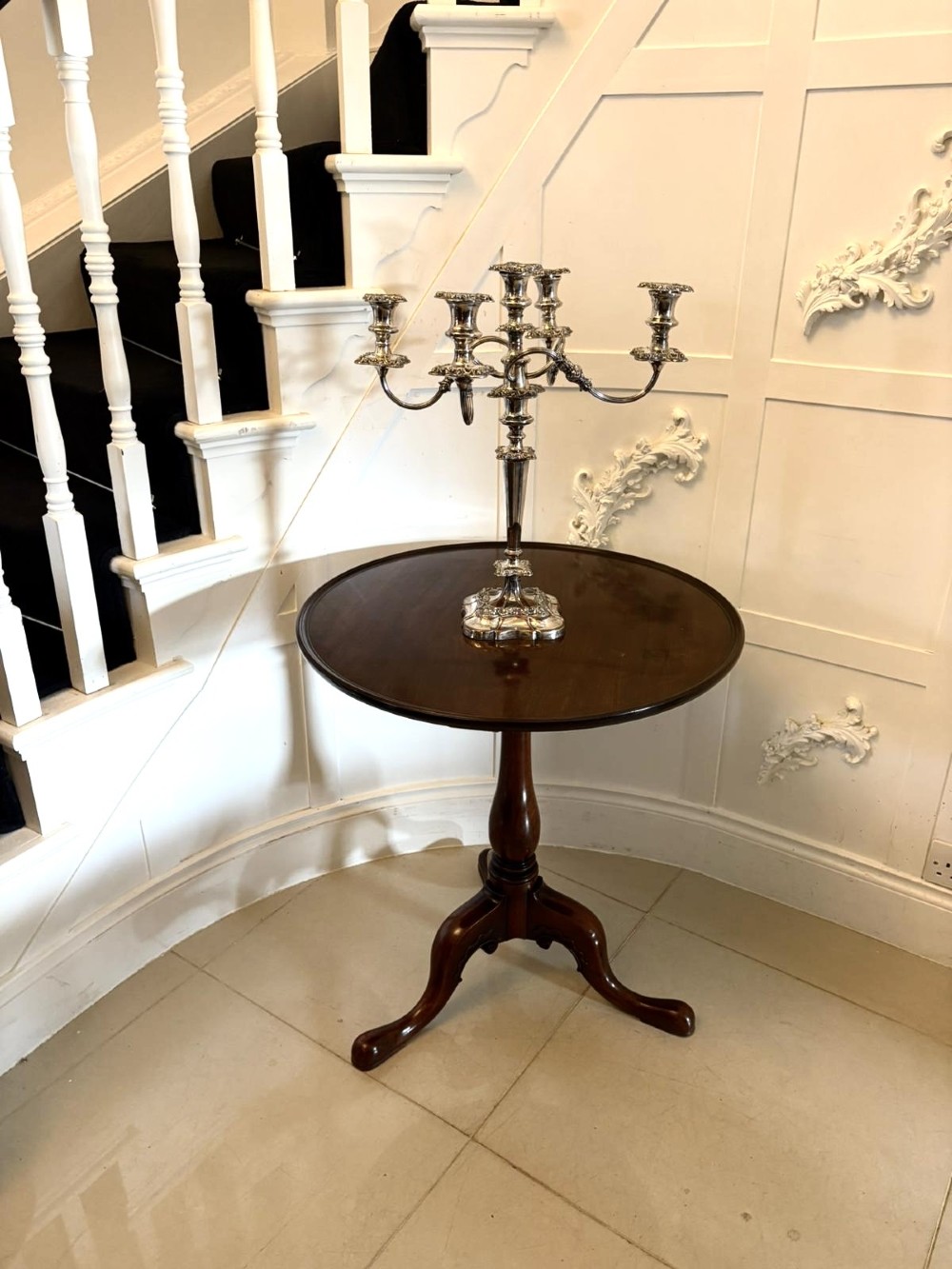 A Georgian mahogany tripod table with a circular top mounted on a turned pedestal with three cabriole legs. View III