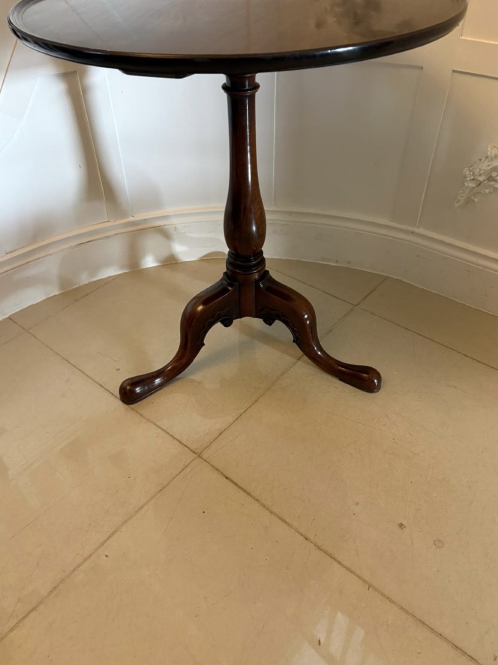 A Georgian mahogany tripod table with a circular top mounted on a turned pedestal with three cabriole legs. View VIII