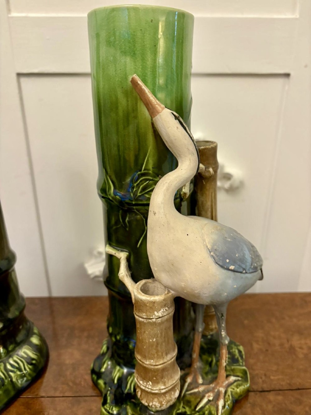 A pair of Victorian green glazed ceramic vases featuring bamboo stems and sculpted wading birds. View X