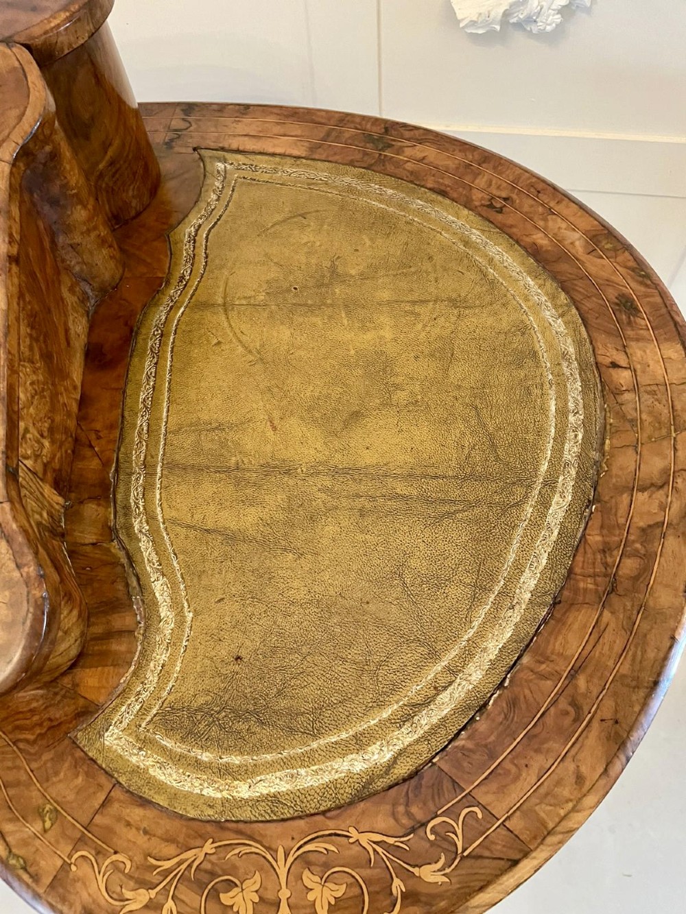 A Victorian burr walnut kidney-shaped writing table with floral marquetry inlay, green leather panels, and a central raised writing slope. View VII