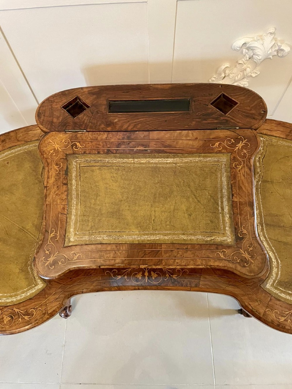A Victorian burr walnut kidney-shaped writing table with floral marquetry inlay, green leather panels, and a central raised writing slope. View XII