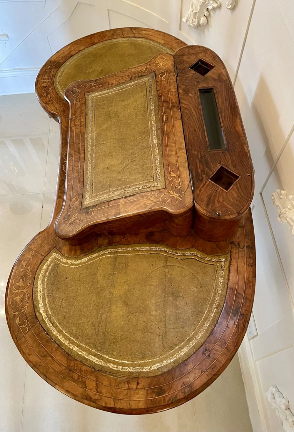 A Victorian burr walnut kidney-shaped writing table with floral marquetry inlay, green leather panels, and a central raised writing slope. View XIII
