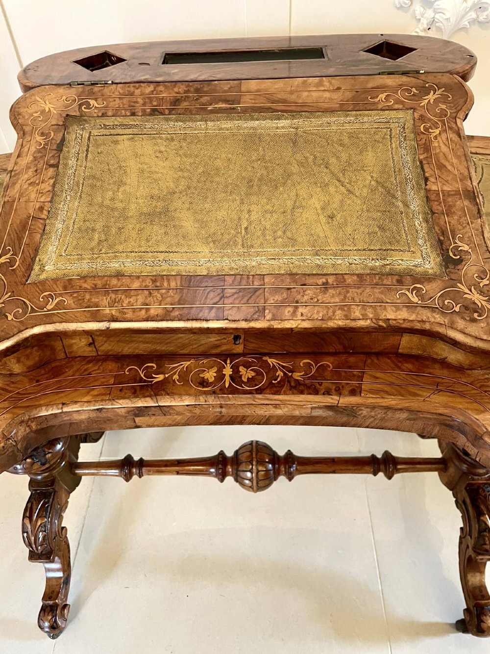 A Victorian burr walnut kidney-shaped writing table with floral marquetry inlay, green leather panels, and a central raised writing slope. View XIV