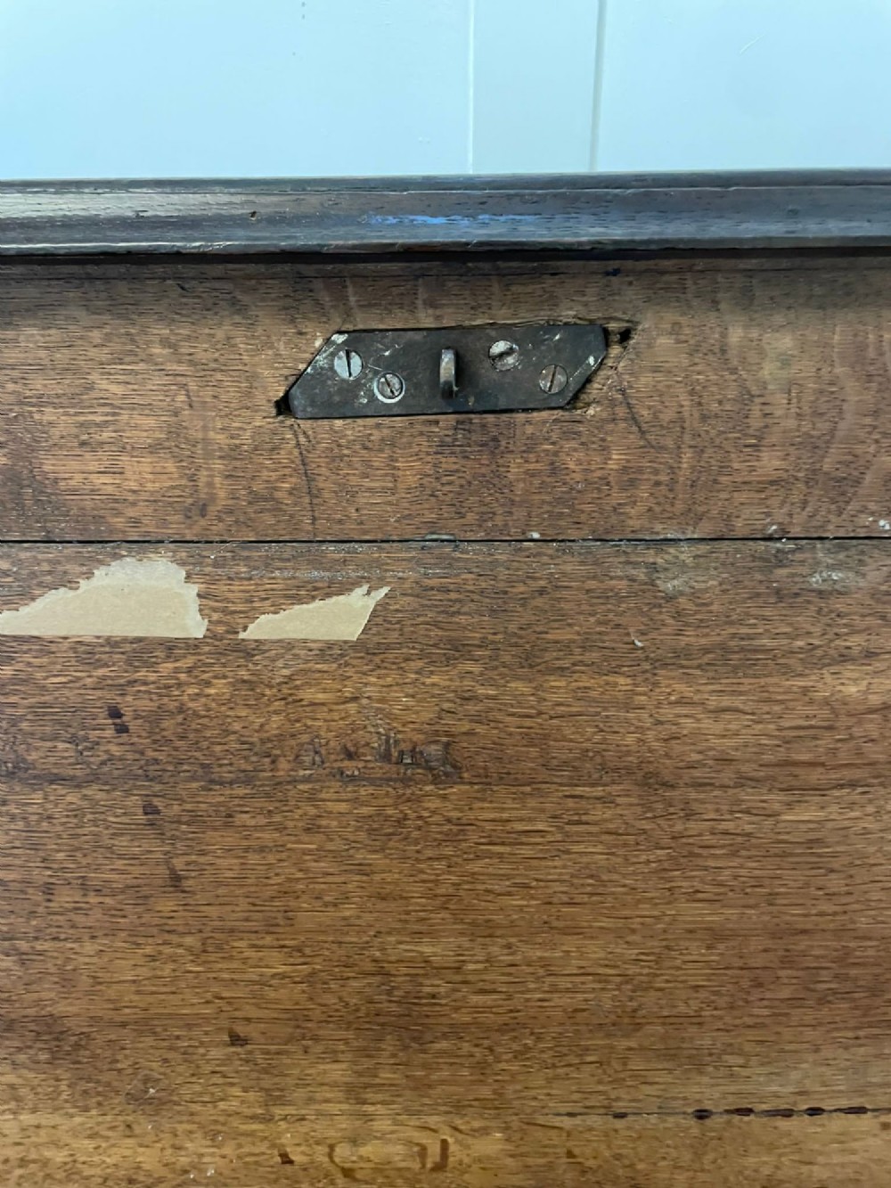 An 18th-century dark oak mule chest featuring four panelled facade sections above two lower drawers with brass handles. View II