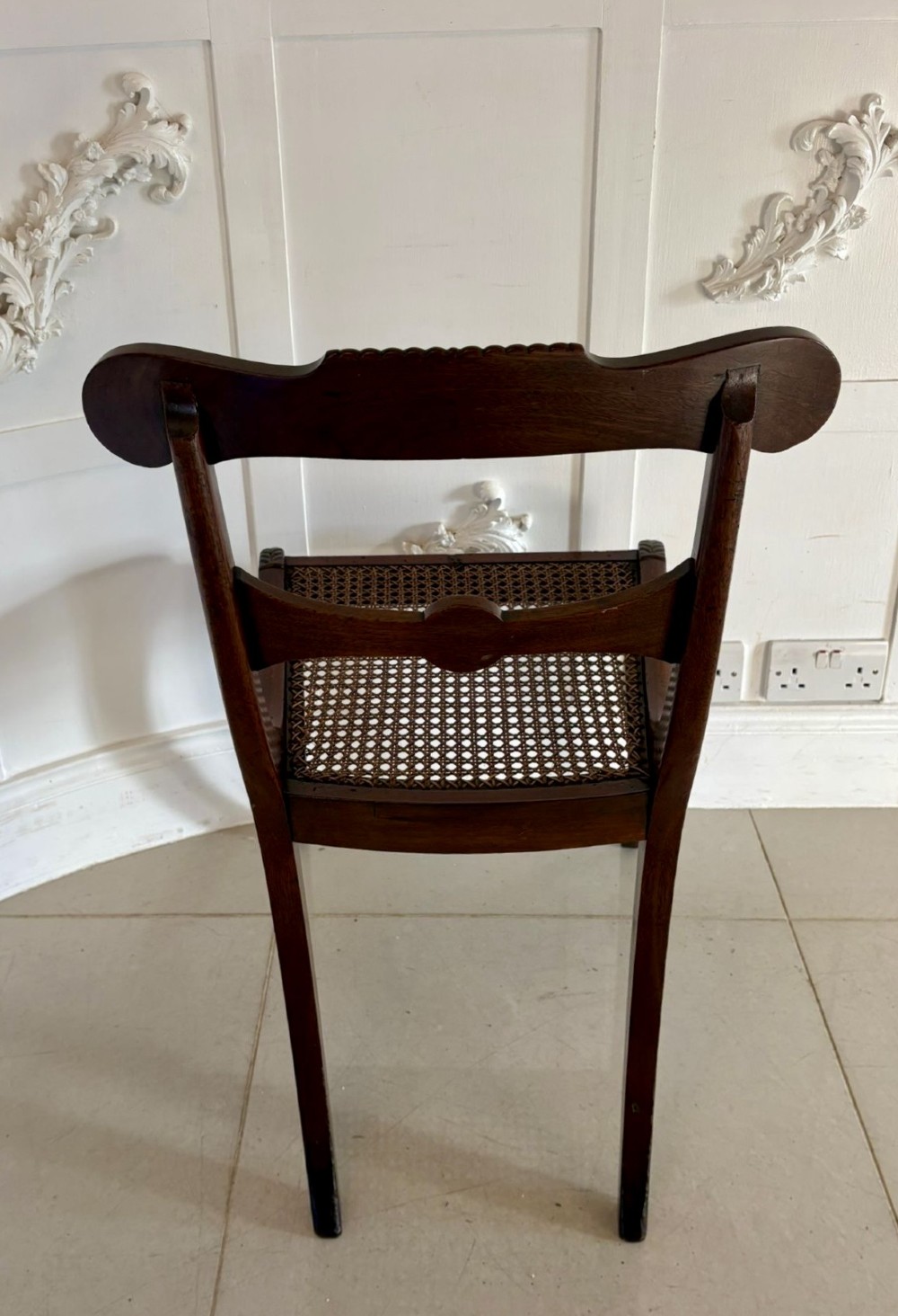 A set of six Regency mahogany dining chairs featuring carved bar-back crest rails, rosettes, and green tartan fabric upholstery. View II