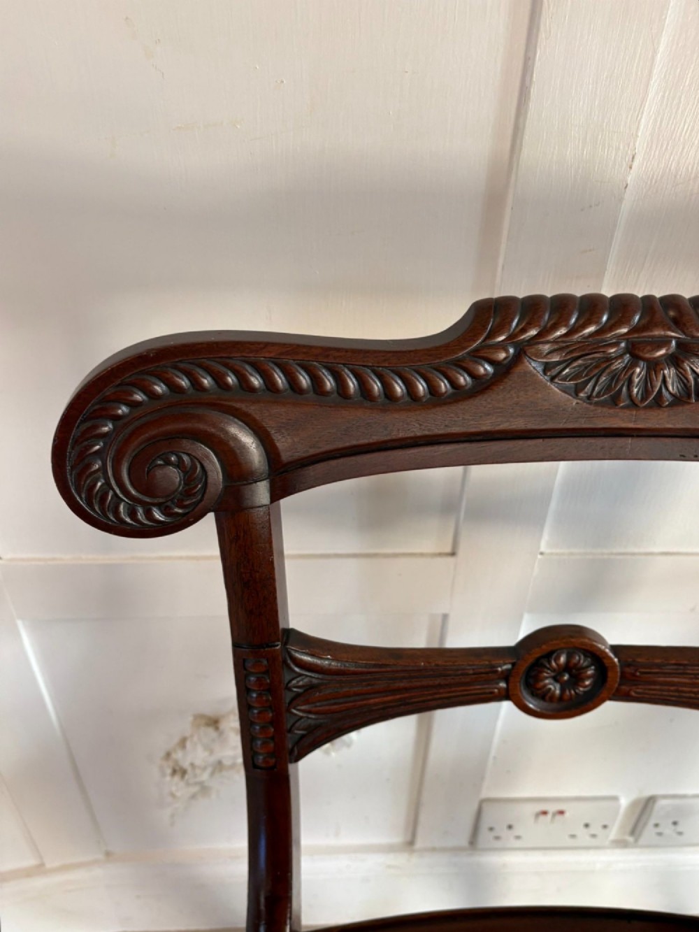 A set of six Regency mahogany dining chairs featuring carved bar-back crest rails, rosettes, and green tartan fabric upholstery. View XI