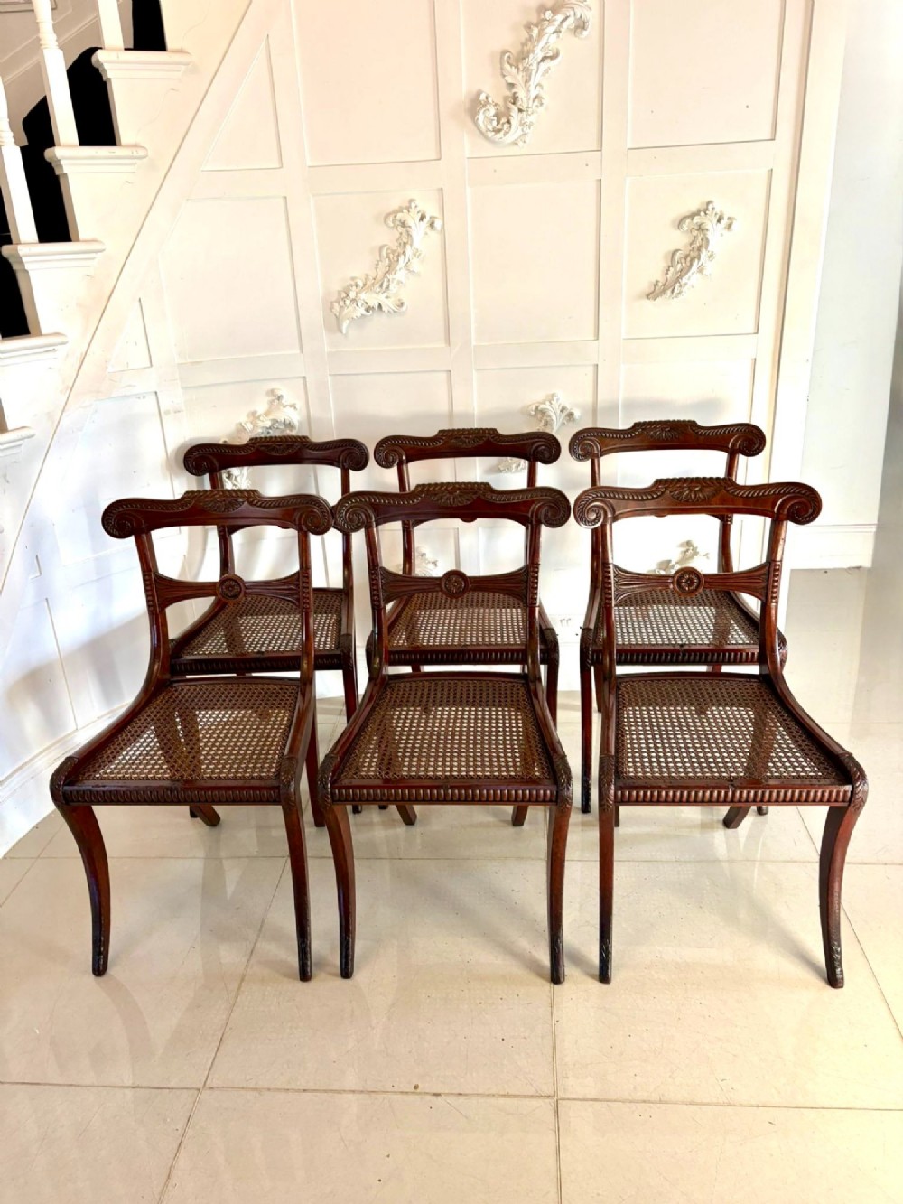 A set of six Regency mahogany dining chairs featuring carved bar-back crest rails, rosettes, and green tartan fabric upholstery. View XII