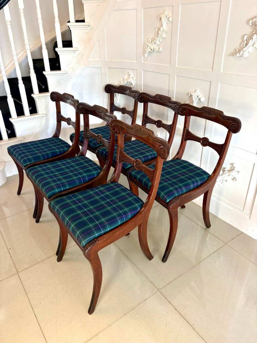 A set of six Regency mahogany dining chairs featuring carved bar-back crest rails, rosettes, and green tartan fabric upholstery. View XIII