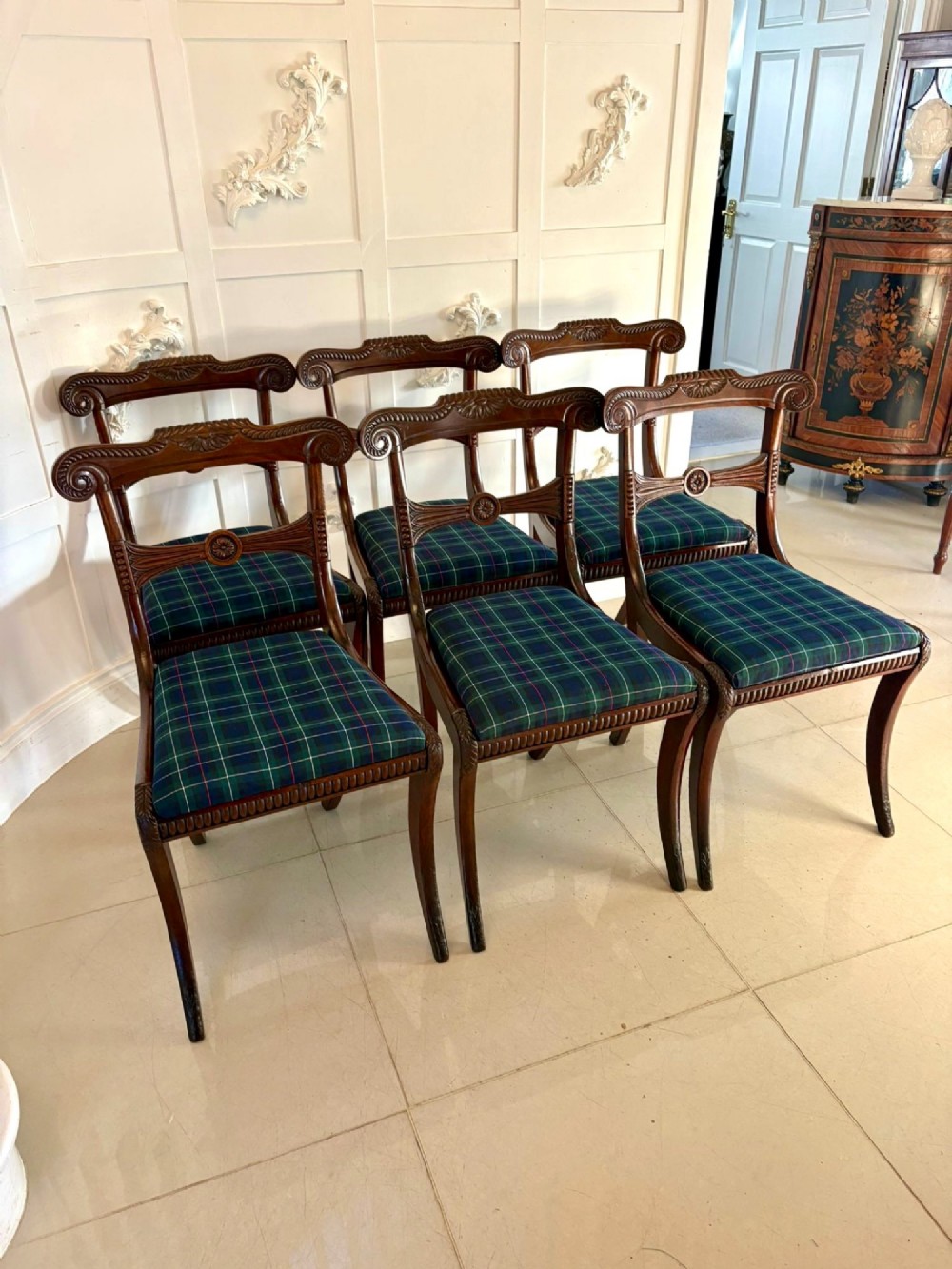 A set of six Regency mahogany dining chairs featuring carved bar-back crest rails, rosettes, and green tartan fabric upholstery. View XIV