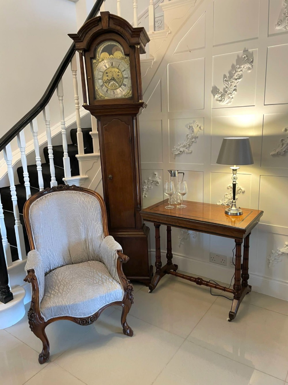 An Arts and Crafts oak side table featuring dark ebony inlay around the rectangular fold-over top, dual turned legs on a stretcher base, and ceramic castors. View II