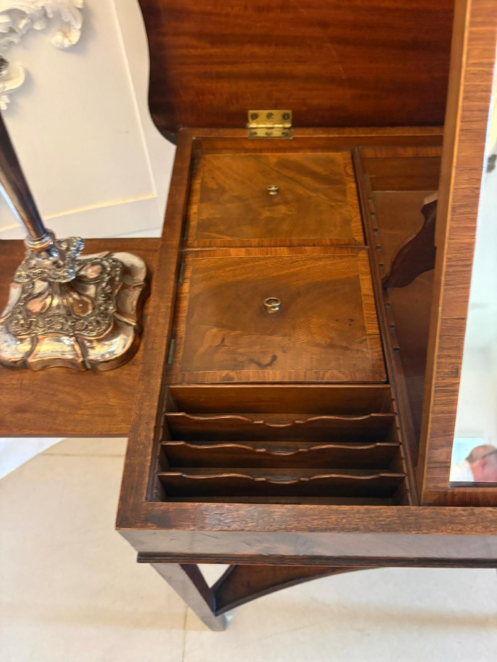 An antique mahogany dressing table with an open hinged lid displaying an internal mirror, storage compartments, side slides, and a shaped lower shelf. View VI