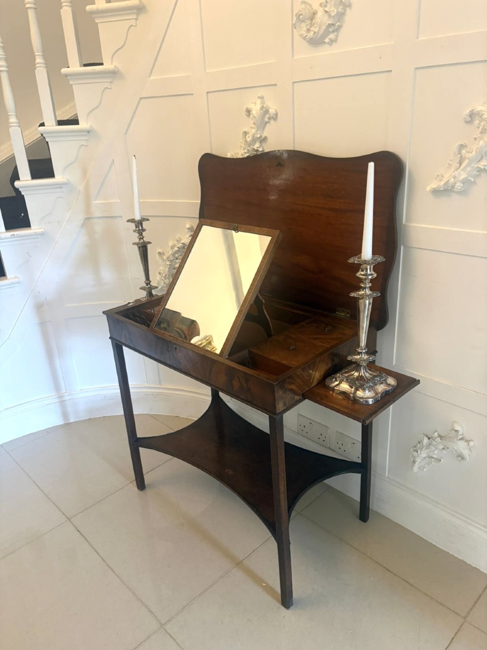 An antique mahogany dressing table with an open hinged lid displaying an internal mirror, storage compartments, side slides, and a shaped lower shelf. View VIII