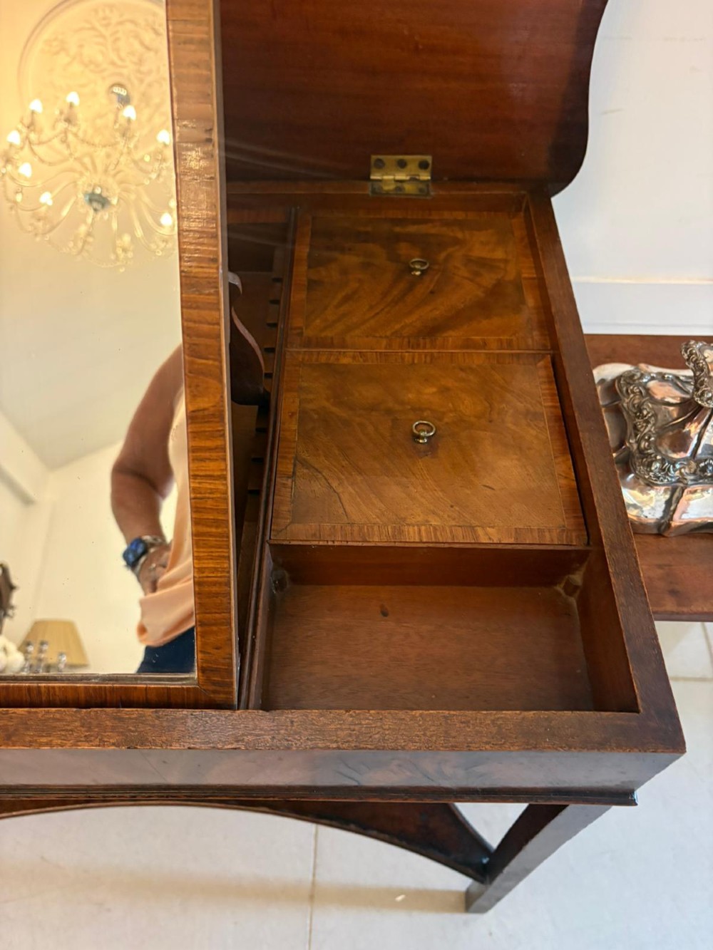 An antique mahogany dressing table with an open hinged lid displaying an internal mirror, storage compartments, side slides, and a shaped lower shelf. View XI