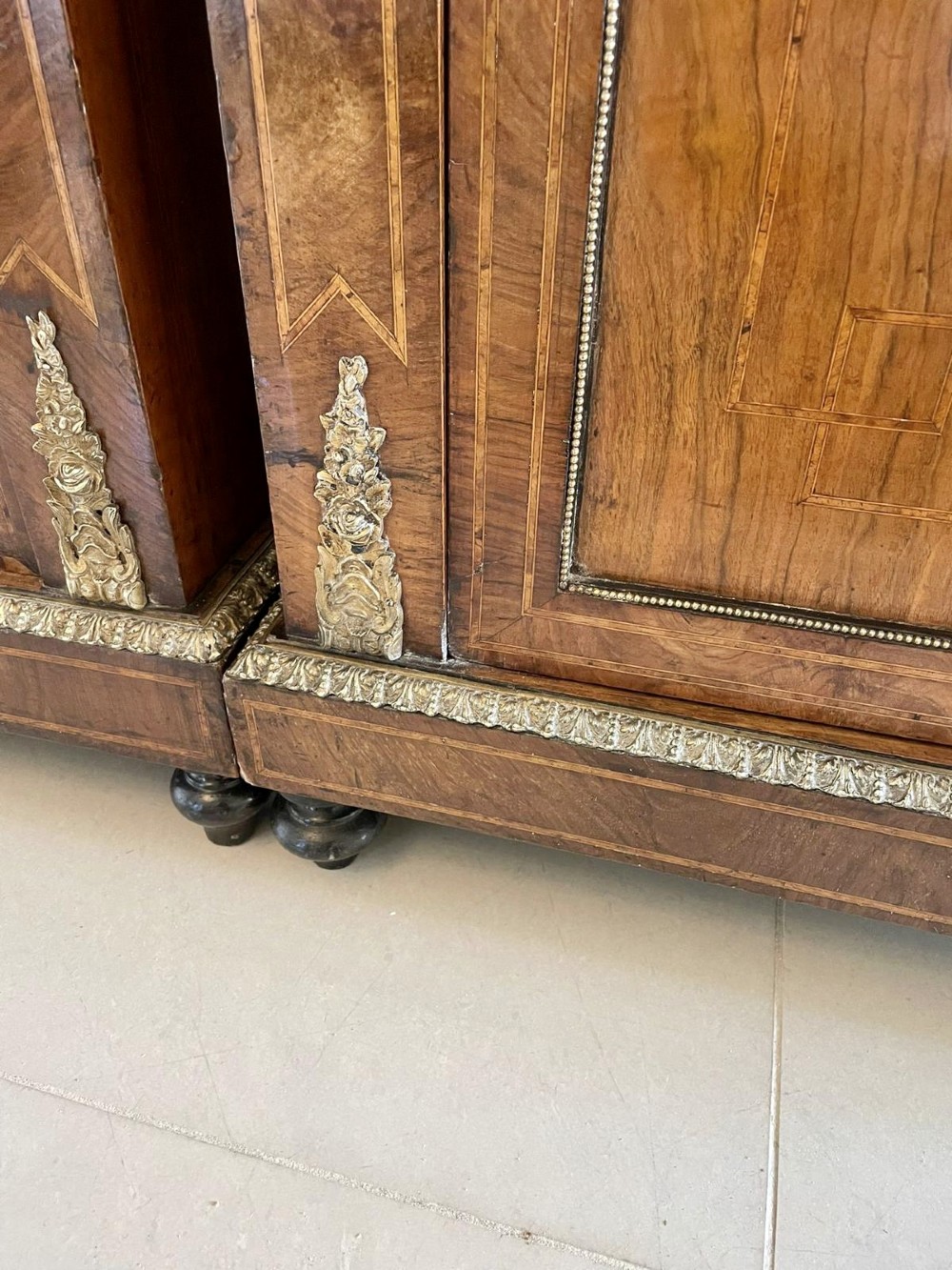 A pair of Victorian burr walnut pier cabinets featuring inlaid wood borders, gilt-bronze mounts, and central oval painted porcelain plaques. View V