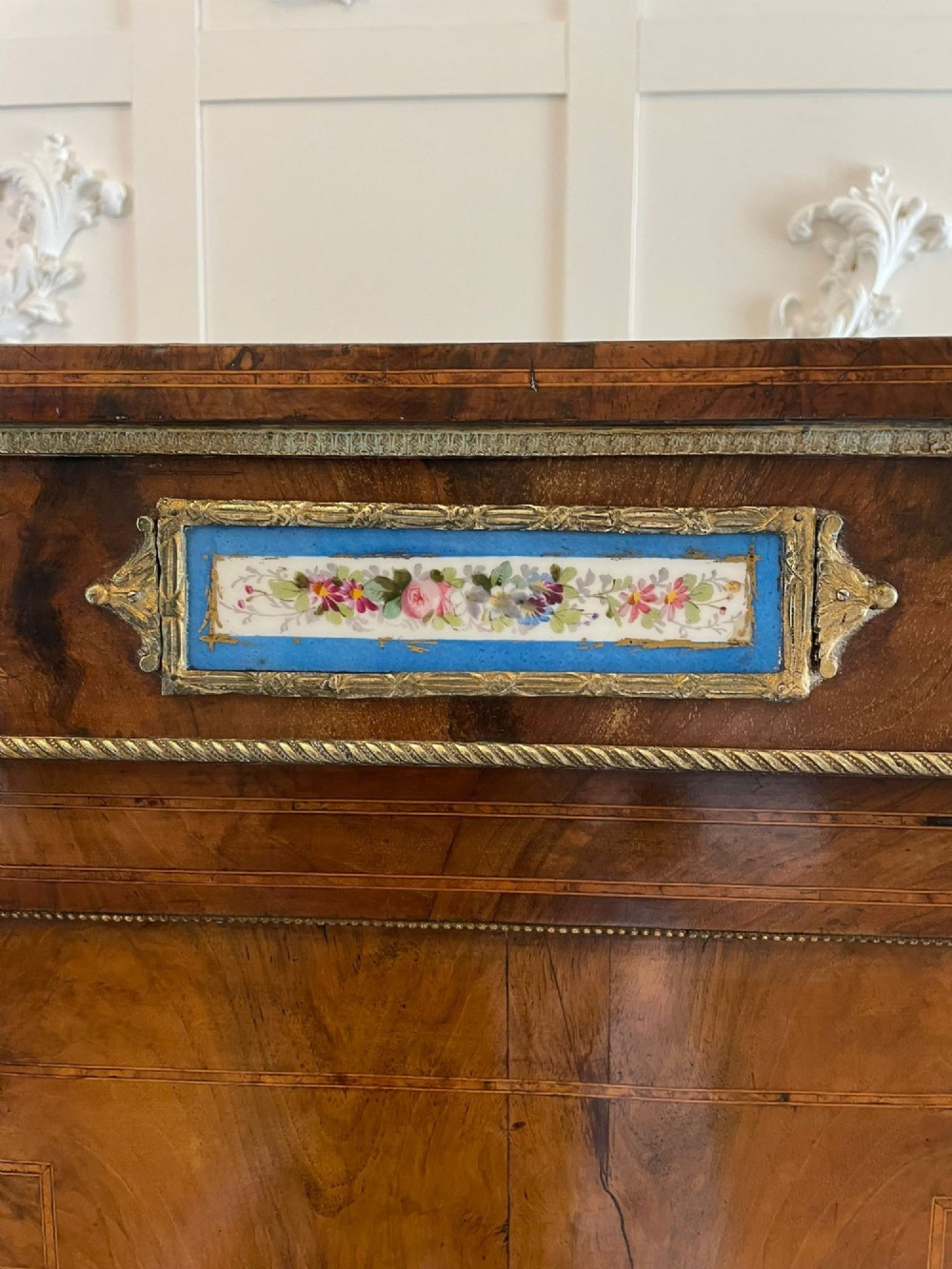 A pair of Victorian burr walnut pier cabinets featuring inlaid wood borders, gilt-bronze mounts, and central oval painted porcelain plaques. View VII