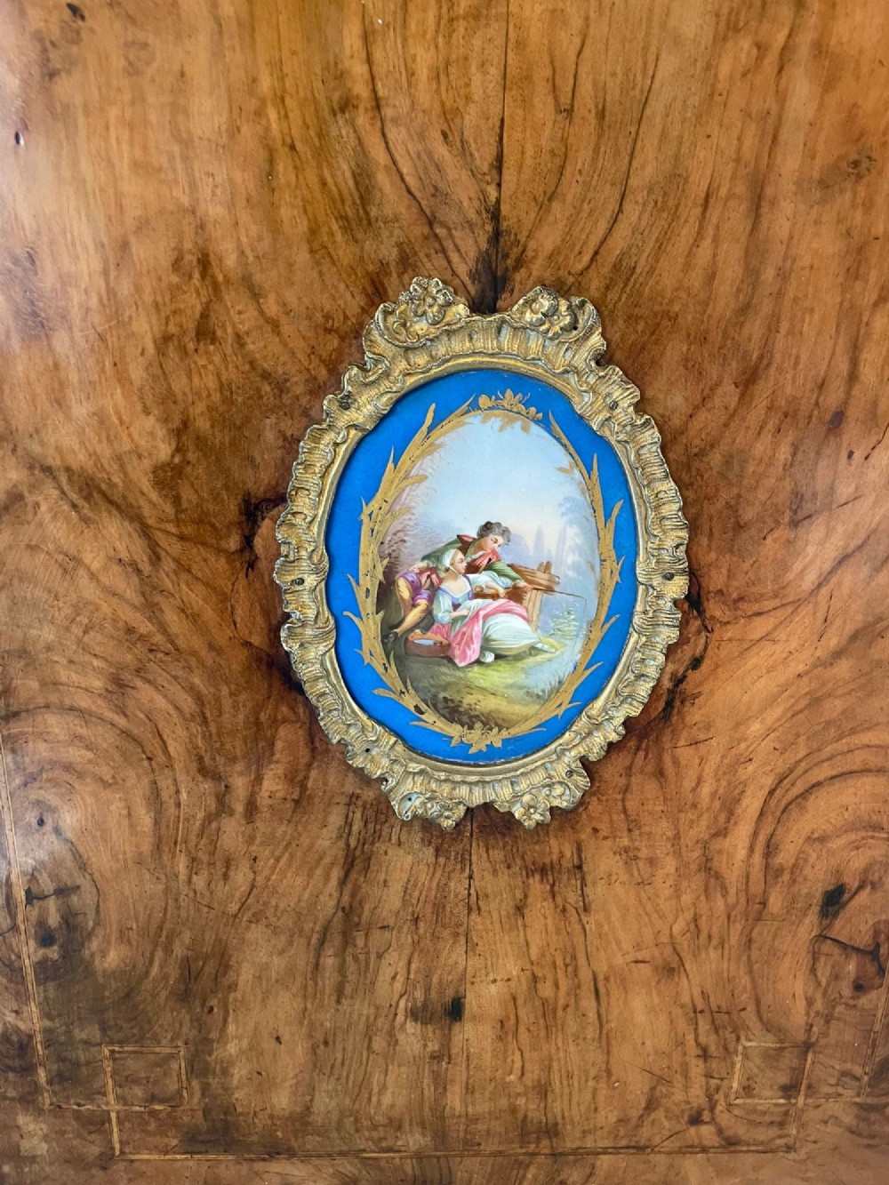 A pair of Victorian burr walnut pier cabinets featuring inlaid wood borders, gilt-bronze mounts, and central oval painted porcelain plaques. View VIII