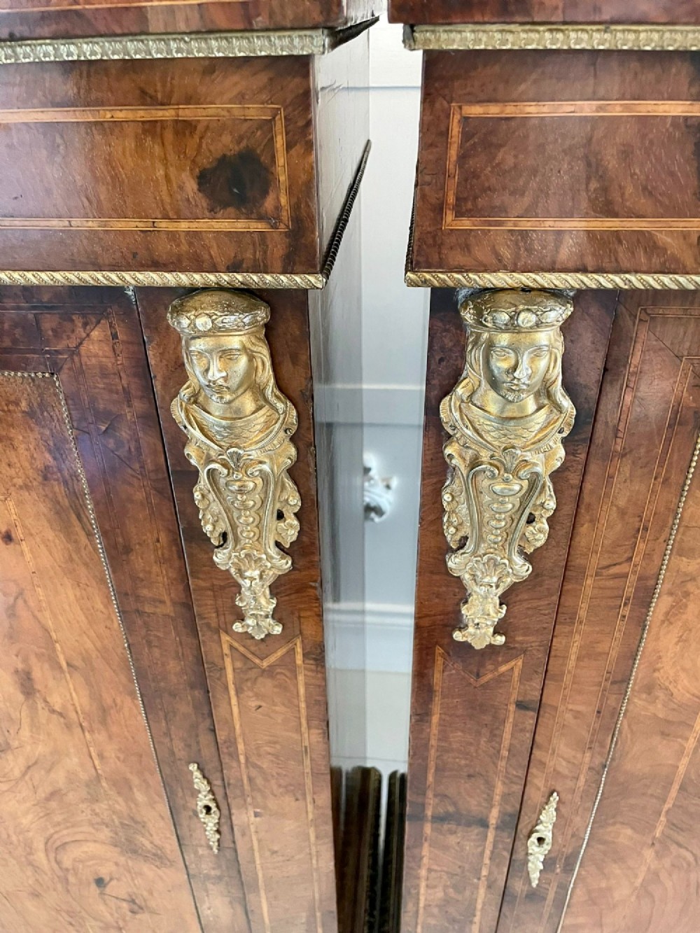 A pair of Victorian burr walnut pier cabinets featuring inlaid wood borders, gilt-bronze mounts, and central oval painted porcelain plaques. View XII