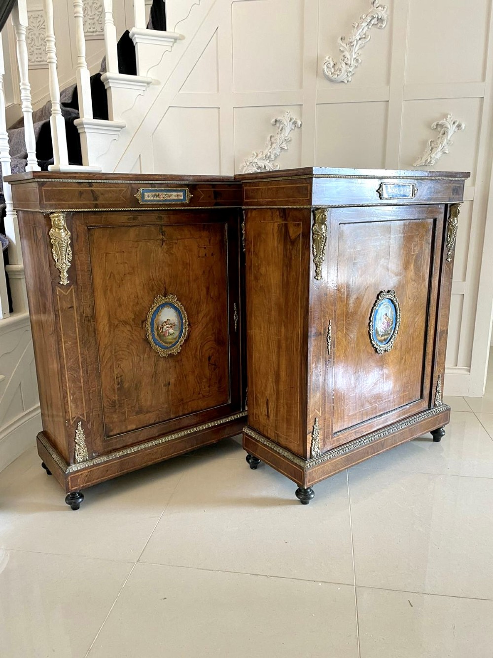 A pair of Victorian burr walnut pier cabinets featuring inlaid wood borders, gilt-bronze mounts, and central oval painted porcelain plaques. View XIV