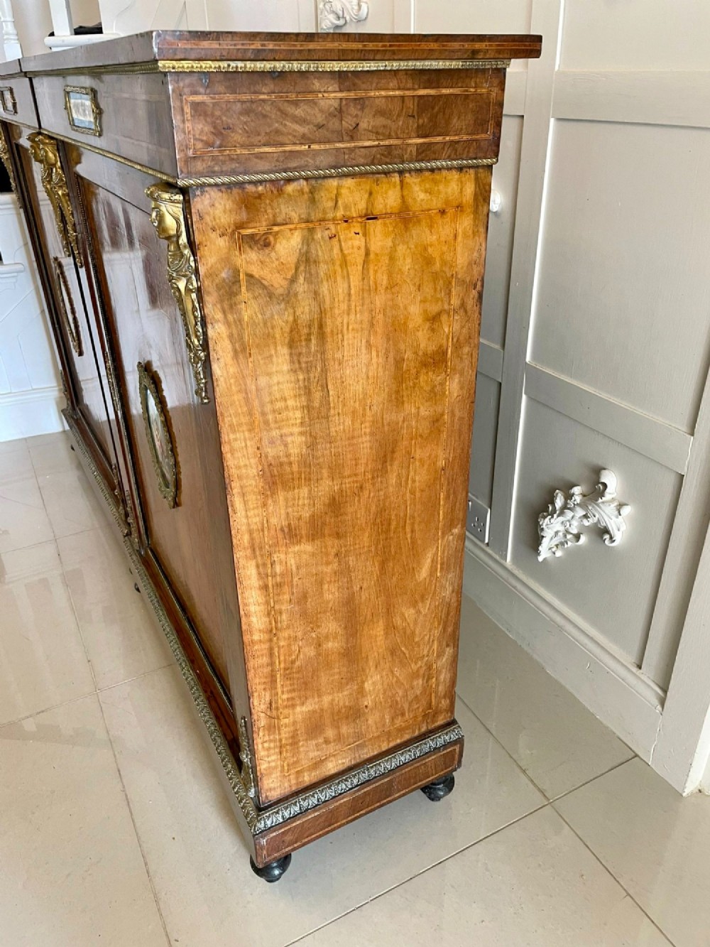 A pair of Victorian burr walnut pier cabinets featuring inlaid wood borders, gilt-bronze mounts, and central oval painted porcelain plaques. View XV