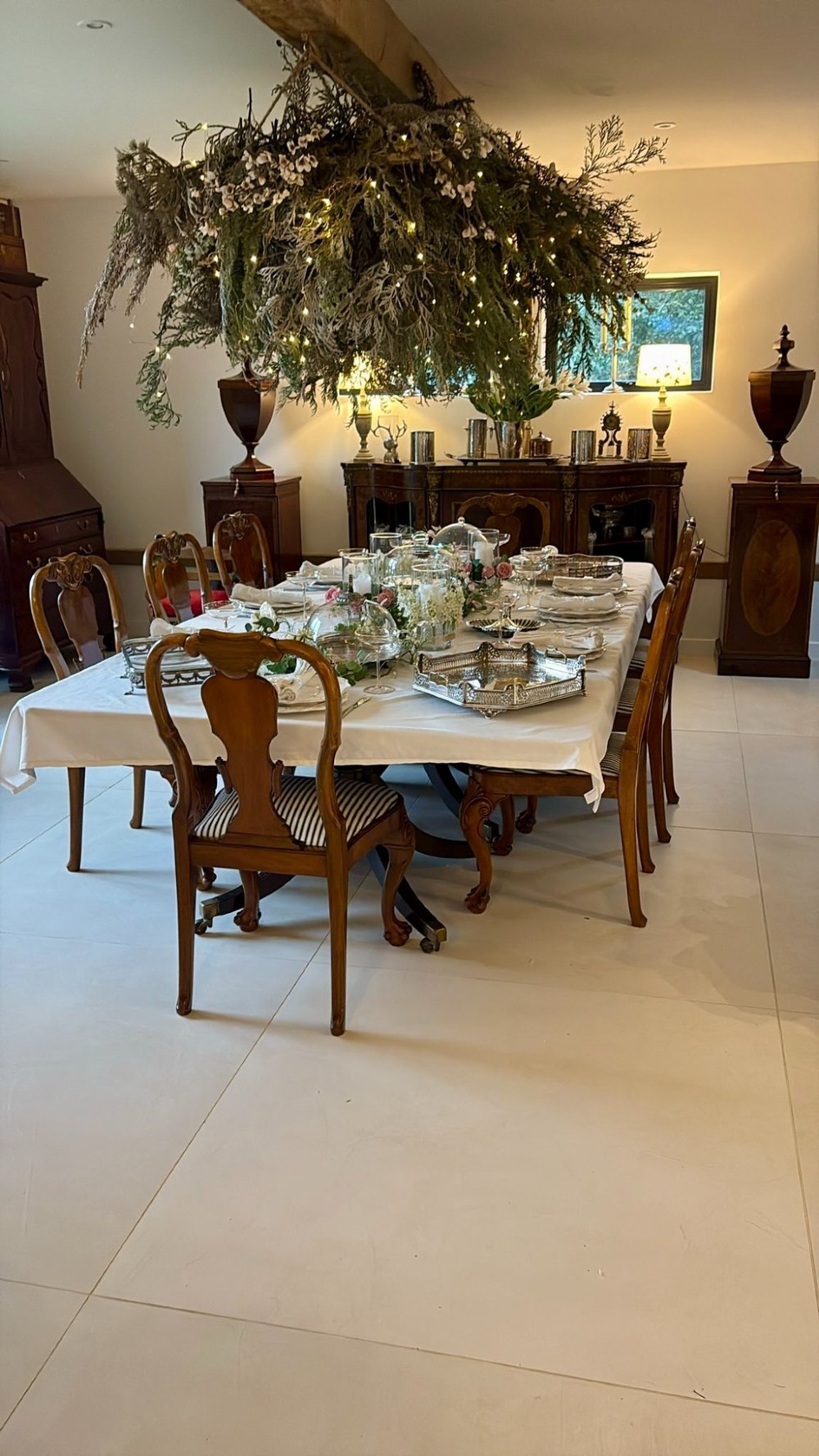 A set of twelve Victorian burr walnut dining chairs featuring carved splats, striped upholstered seats, and cabriole legs terminating in claw and ball feet. View III