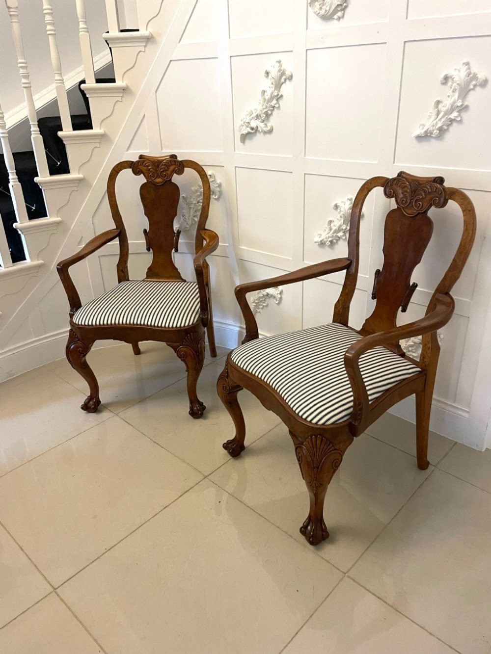 A set of twelve Victorian burr walnut dining chairs featuring carved splats, striped upholstered seats, and cabriole legs terminating in claw and ball feet. View VIII