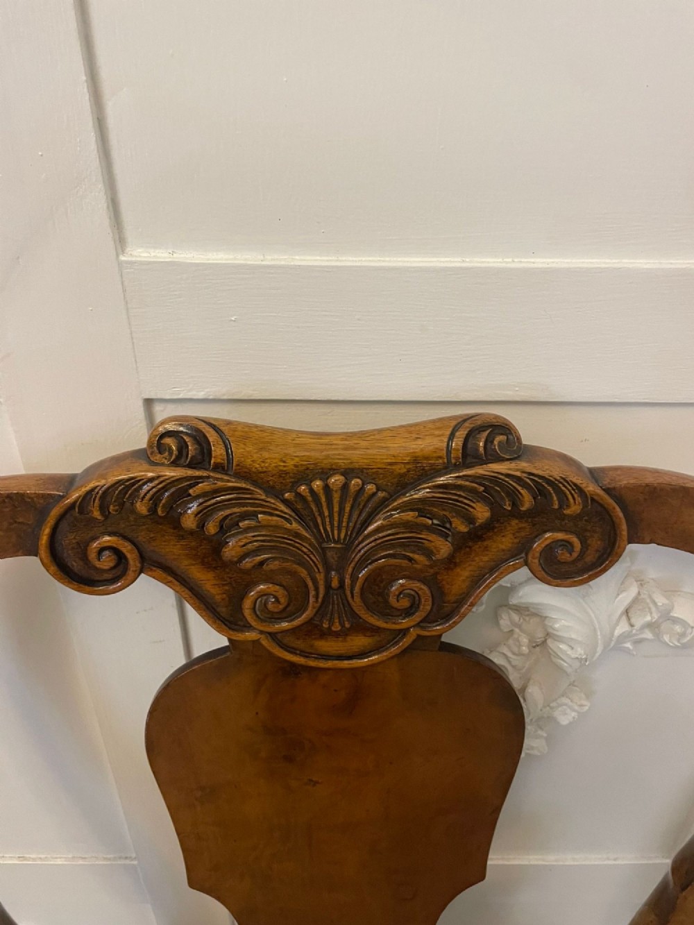 A set of twelve Victorian burr walnut dining chairs featuring carved splats, striped upholstered seats, and cabriole legs terminating in claw and ball feet. View XIII