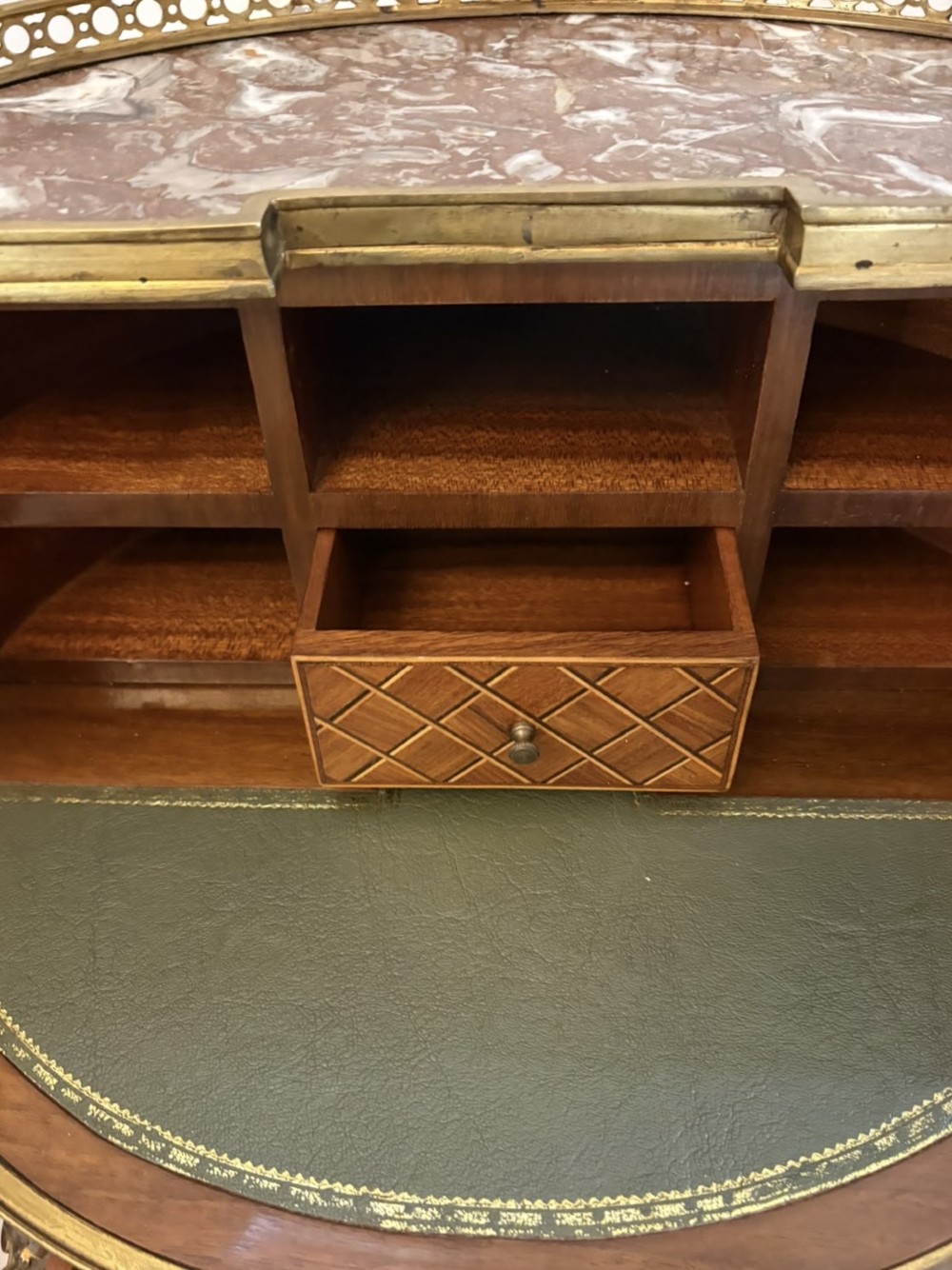 A French kingwood parquetry bonheur du jour writing desk featuring a green leather inset, marble top gallery, and gilt-bronze mounts on slender cabriole legs. View V