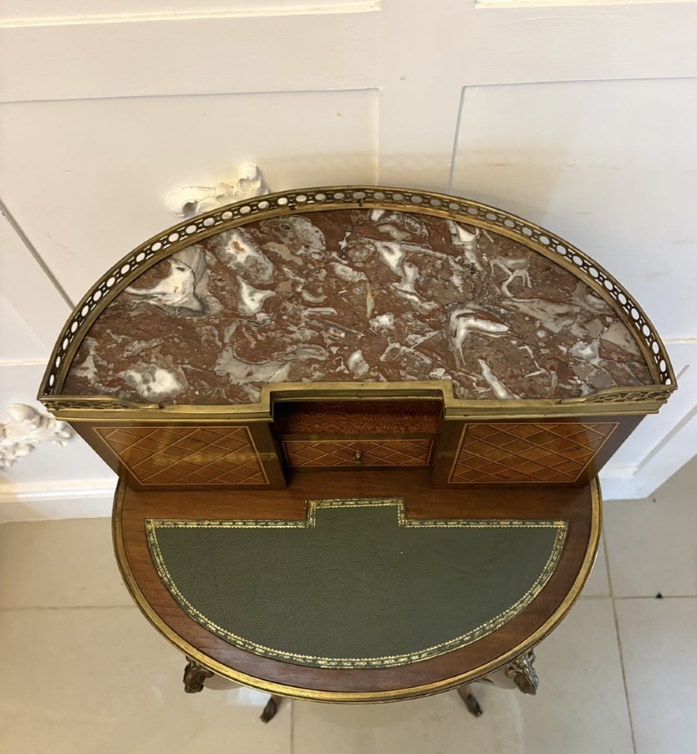 A French kingwood parquetry bonheur du jour writing desk featuring a green leather inset, marble top gallery, and gilt-bronze mounts on slender cabriole legs. View VI