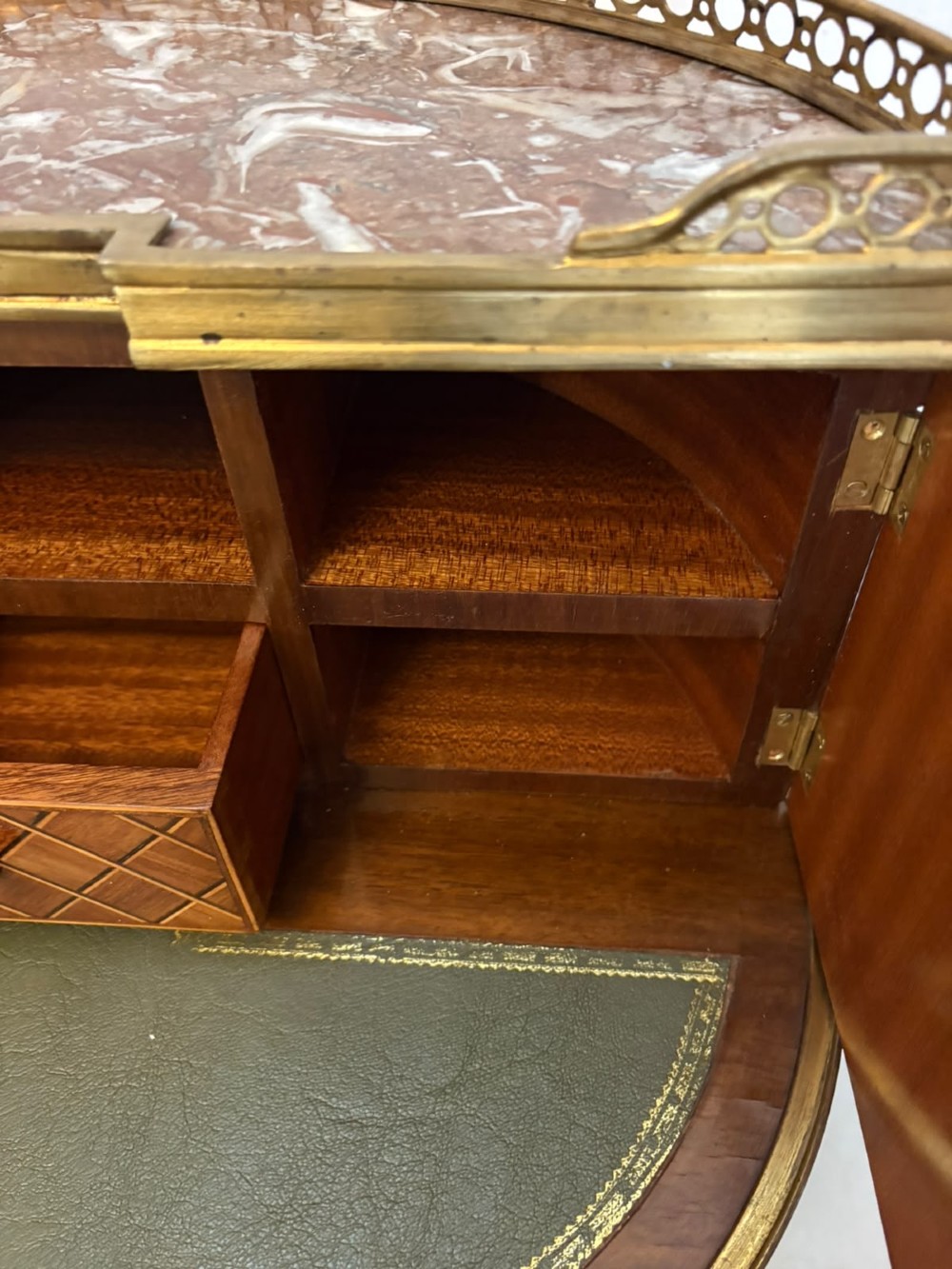 A French kingwood parquetry bonheur du jour writing desk featuring a green leather inset, marble top gallery, and gilt-bronze mounts on slender cabriole legs. View VII
