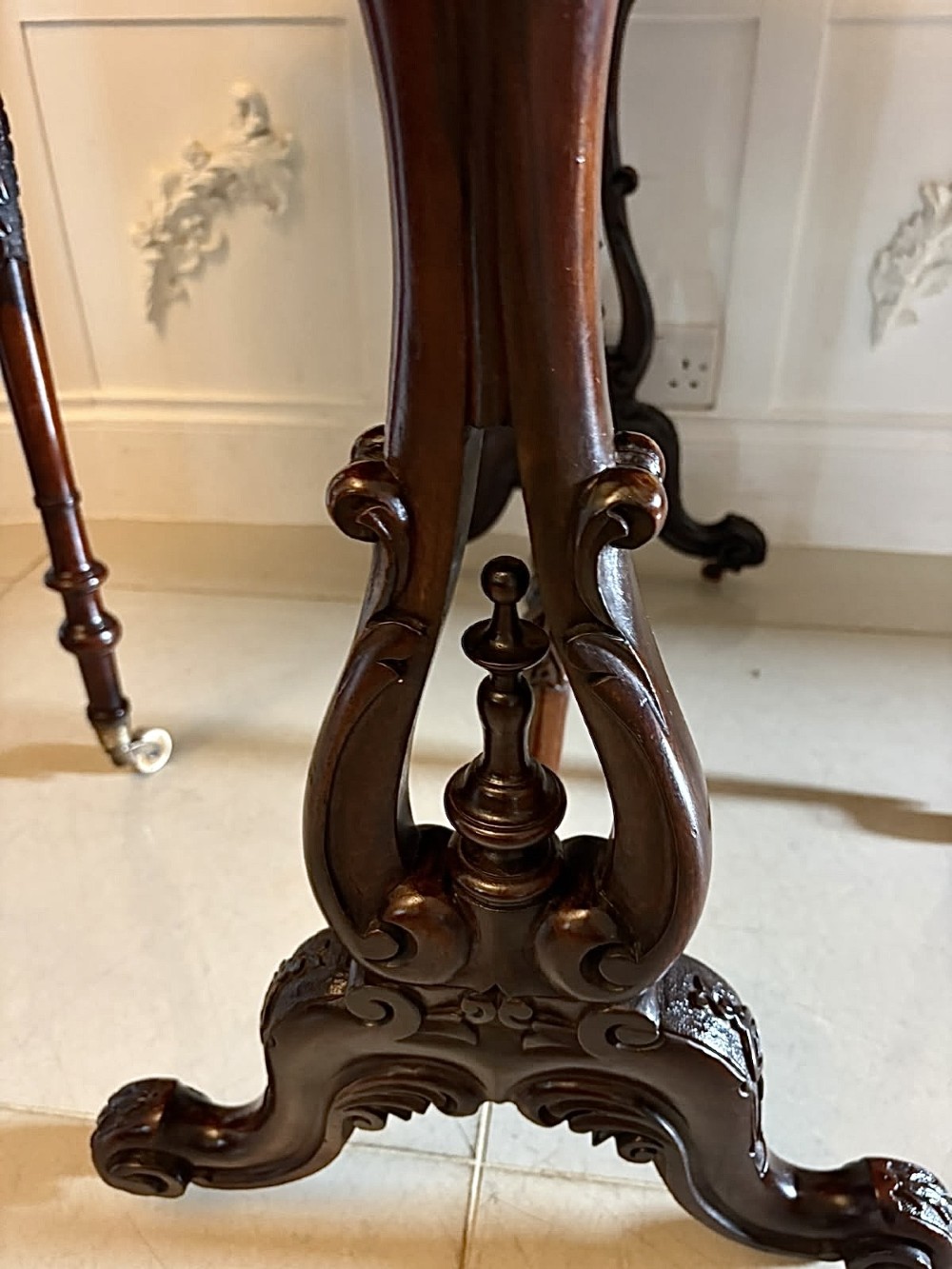 An antique Victorian rosewood Sutherland table with drop leaves, carved legs, and brass castors. View IX