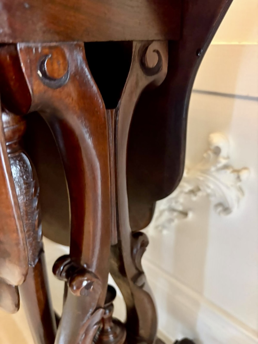 An antique Victorian rosewood Sutherland table with drop leaves, carved legs, and brass castors. View XIII