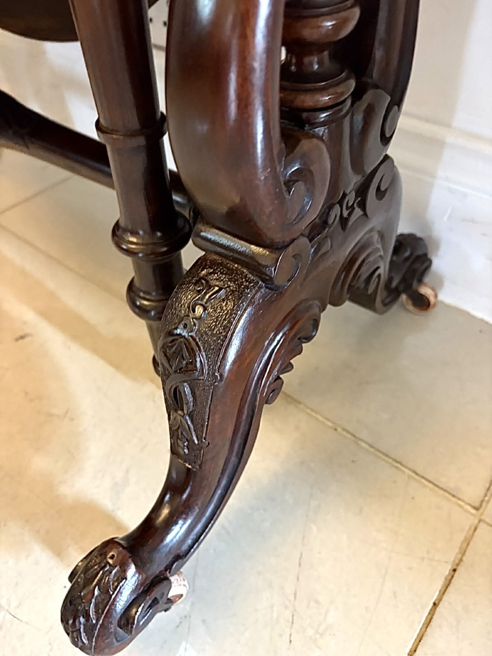 An antique Victorian rosewood Sutherland table with drop leaves, carved legs, and brass castors. View XIV