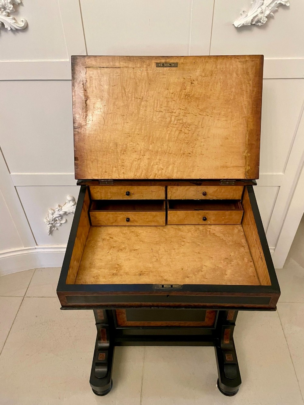 A Victorian ebonised davenport desk featuring walnut crossbanding, a sloped green leather writing surface, side drawers, and a top brass gallery rail. View II