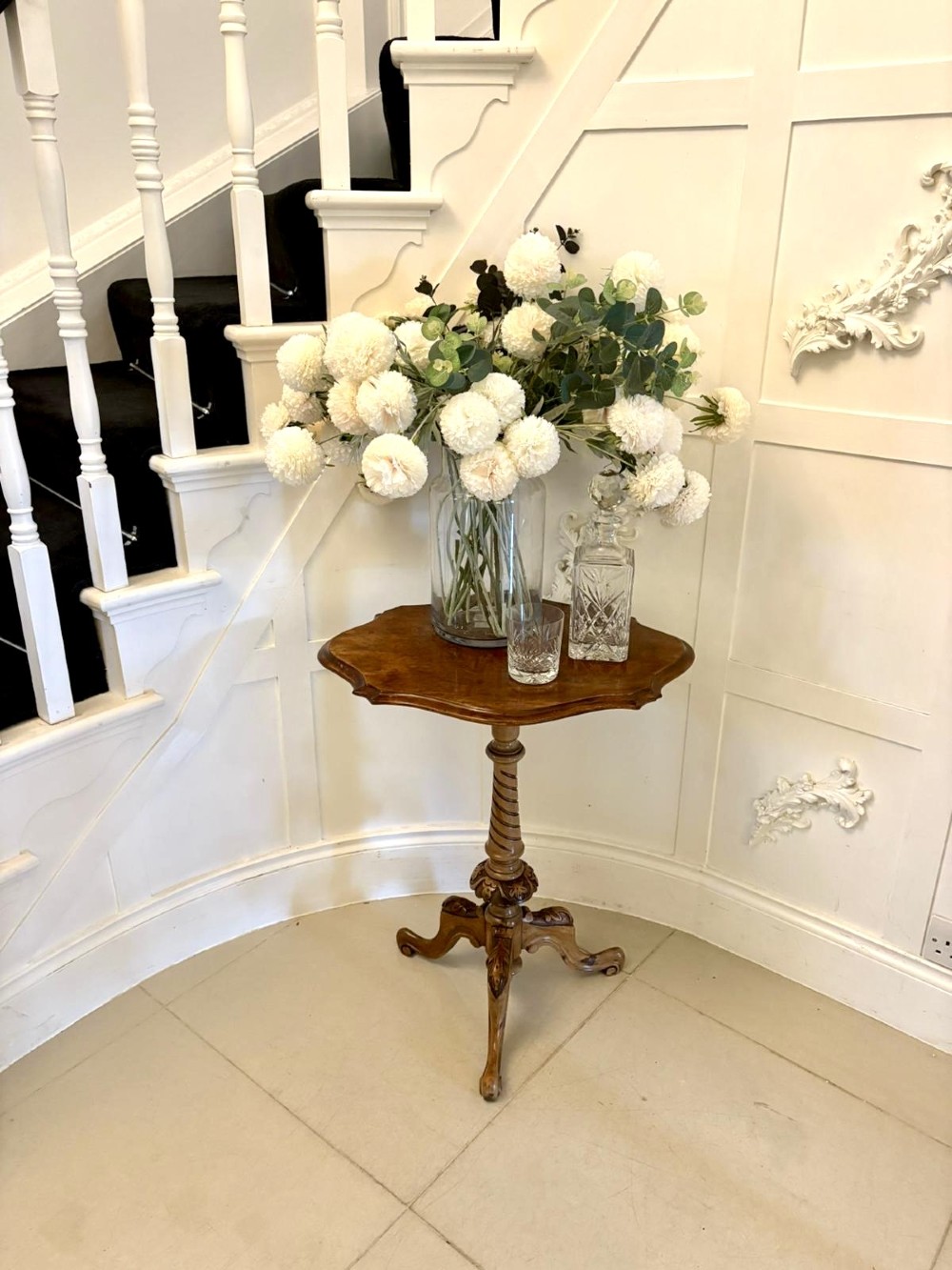 An antique Victorian burr walnut side table featuring a shaped scalloped top, a spiral carved pedestal column, and three carved cabriole legs. View II