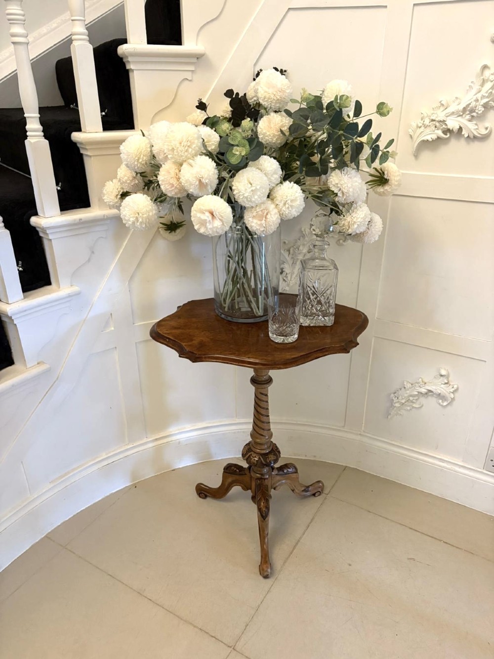 An antique Victorian burr walnut side table featuring a shaped scalloped top, a spiral carved pedestal column, and three carved cabriole legs. View III