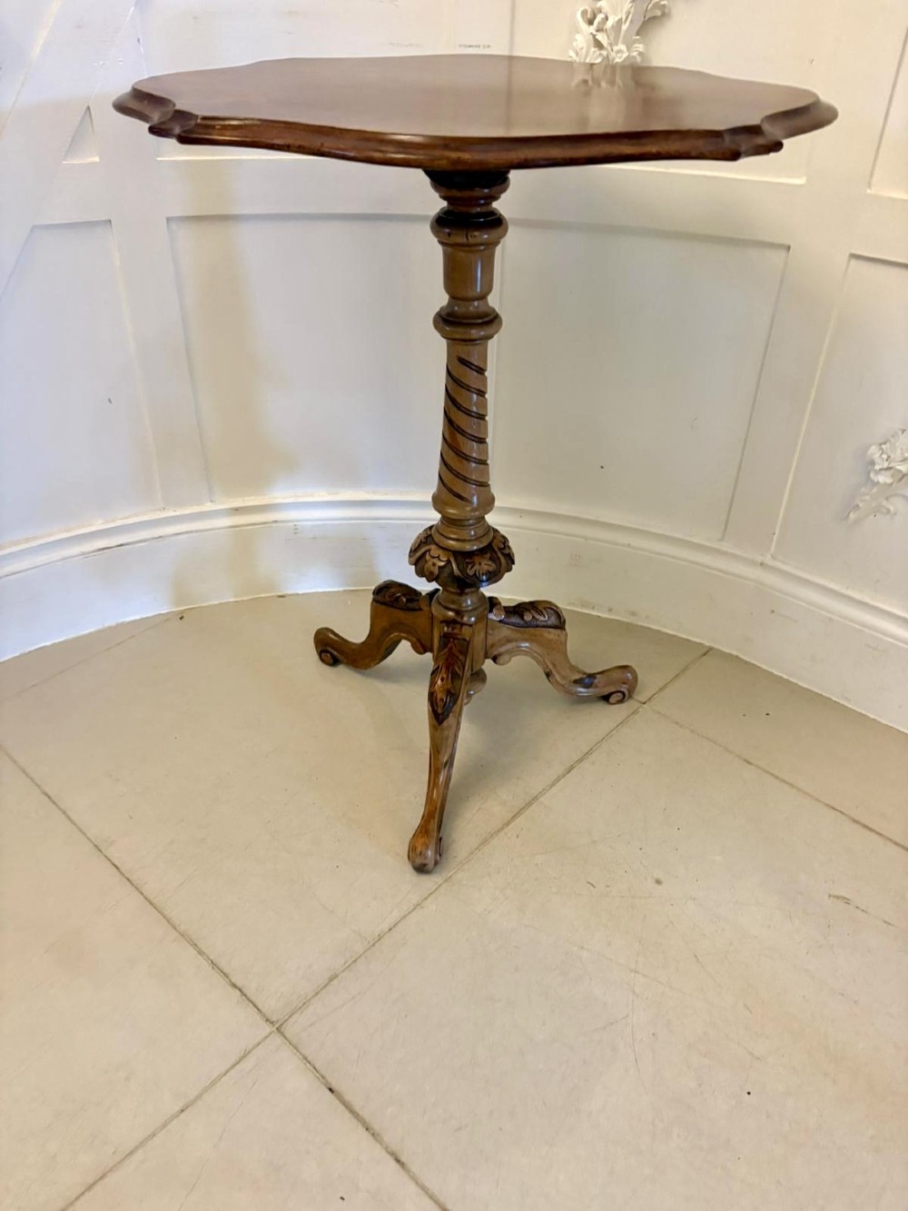 An antique Victorian burr walnut side table featuring a shaped scalloped top, a spiral carved pedestal column, and three carved cabriole legs. View VI