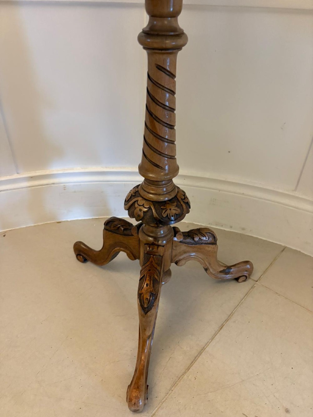An antique Victorian burr walnut side table featuring a shaped scalloped top, a spiral carved pedestal column, and three carved cabriole legs. View VII